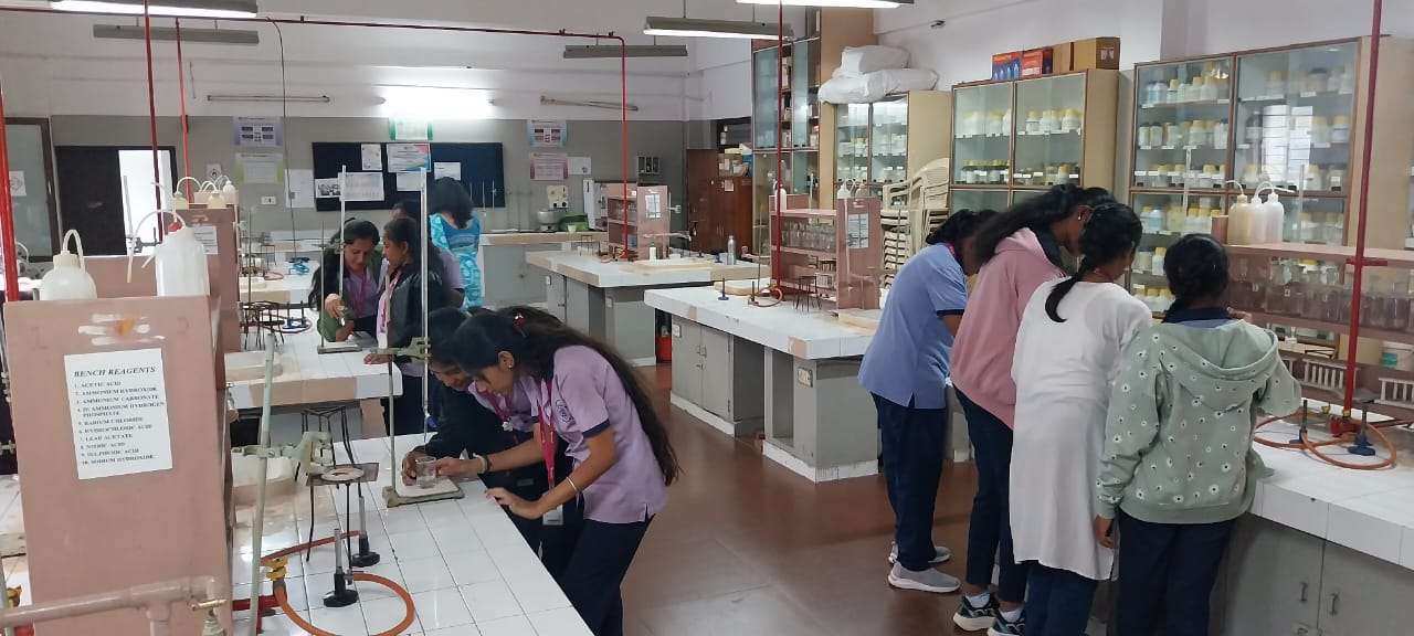 Students conducting experiments in the college chemistry lab